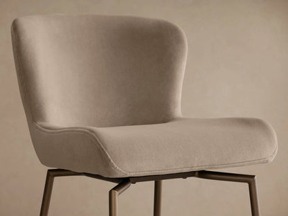 Front view of the beige upholstered Kirsten Swivel Stool with a bronze powder-coated iron frame.