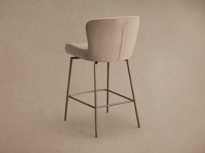 Close-up of the beige Kirsten Swivel Stool, highlighting the curved upholstered seat and backrest, with visible stitching and bronze iron frame.