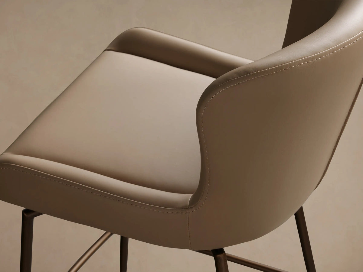 Kirsten Faux Leather Swivel Stool with cream seat and backrest on a brown powder-coated iron frame and legs, on wooden floor.