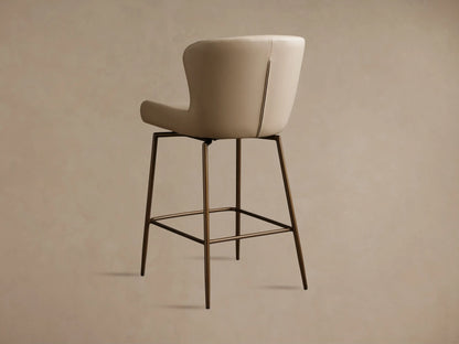 Kirsten Faux Leather Swivel Stool with beige seat, high backrest, and iron legs. Features sleek stitching and a smooth, textured finish.