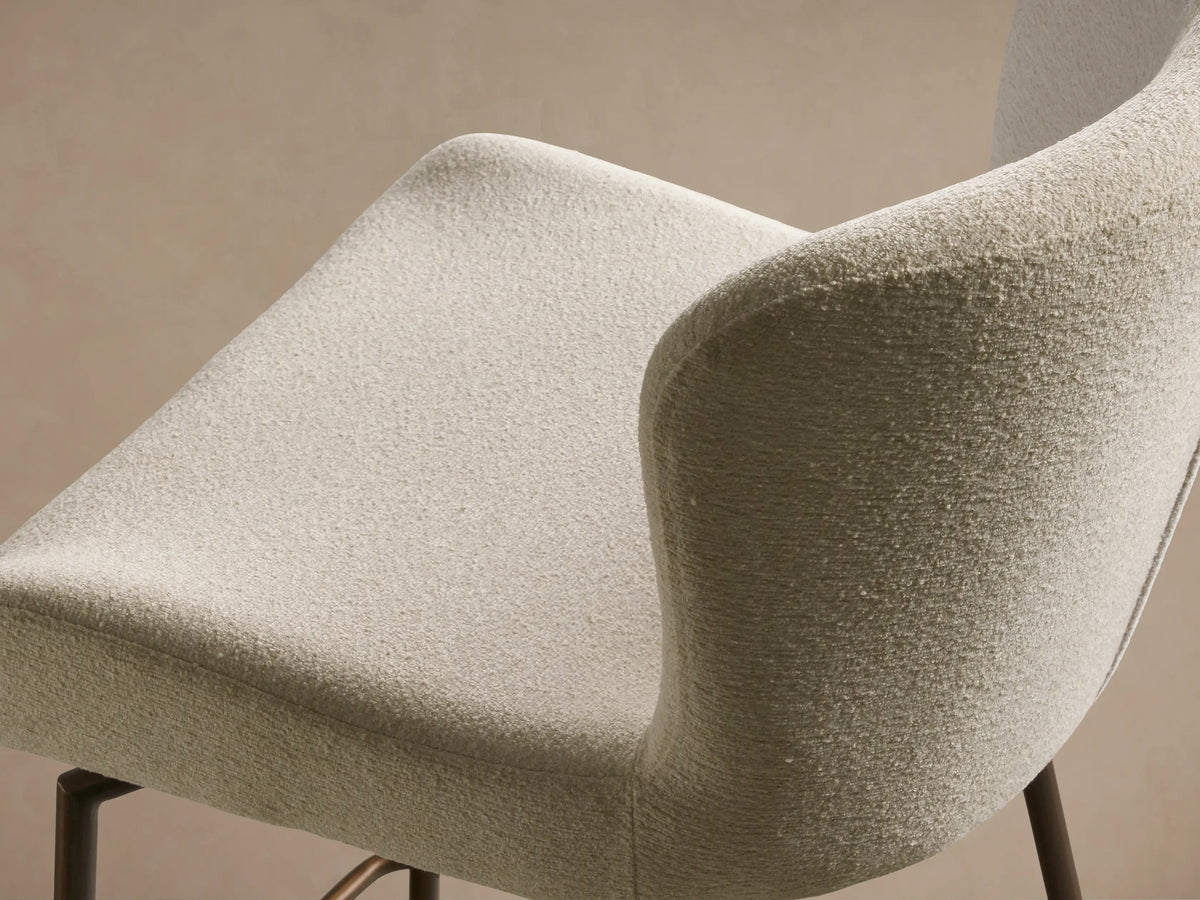 Kirsten Swivel Stool with a cream upholstered seat and backrest. Iron legs are powder-coated brown with a footrest.