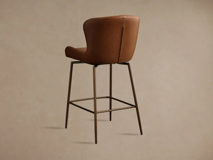 Kirsten Faux Leather Swivel Stool in brown with a curved backrest and armrests, featuring black powder-coated metal legs.
