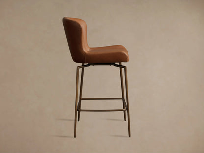 Brown Kirsten Faux Leather Swivel Stool with high backrest, iron frame, and legs; shown in side view on a neutral background.