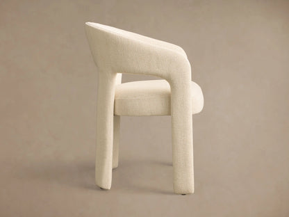 Front view of the cream Lilette Dining Arm Chair, fully upholstered with a curved back and integrated armrests.