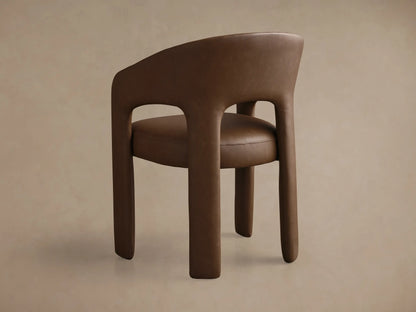 Front view of the brown Lilette Faux Leather Dining Arm Chair, featuring a curved back and integrated armrests.
