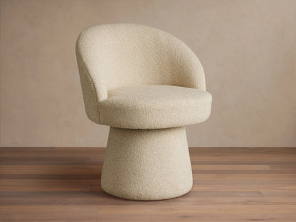 Lindsay Swivel Dining Chair in beige fabric, featuring a curved backrest and round cushioned seat on a tapered base, on a wooden floor.