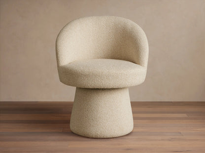 Four beige Lindsay Swivel Dining Chairs, with curved, armless backs and cylindrical bases, around a veined stone dining table.