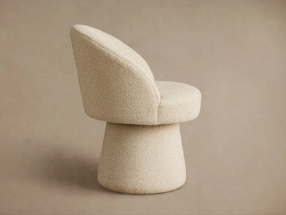 Close-up of the Lindsay Swivel Dining Chair showcasing a textured beige fabric with a looped, nubby surface on the upholstery.