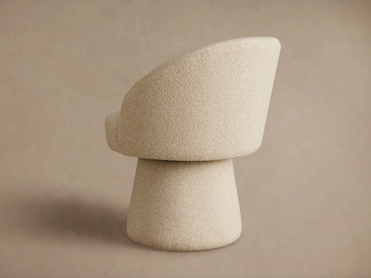 Lindsay Swivel Dining Chair with a textured beige fabric, featuring a rounded backrest and cushioned seat on a sturdy conical base, side view.