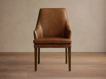 Lunden Faux Leather Dining Arm Chair in brown, featuring a gently curved backrest and armrests, on wooden legs.