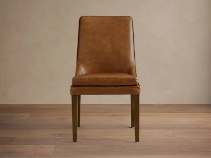 Lunden Dining Side Chair in brown leather with a gently curved backrest and cushioned seat, supported by wooden legs.