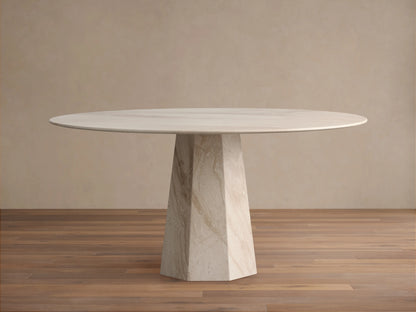 Round light beige marble Modena Dining Table with a geometric pedestal base, centered on a wooden floor.