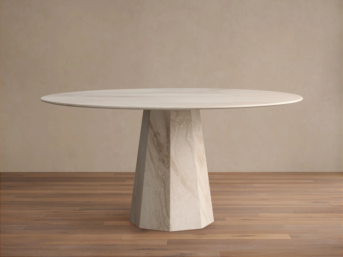 Modena Dining Table: Close-up of smooth, curved beige marble tabletop edge with natural veining, and part of its matching base.