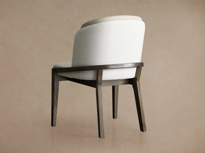 Mena Dining Chair with solid ash wood frame in Vesuvio Black finish, upholstered in beige faux leather and white fabric, shown from the back.