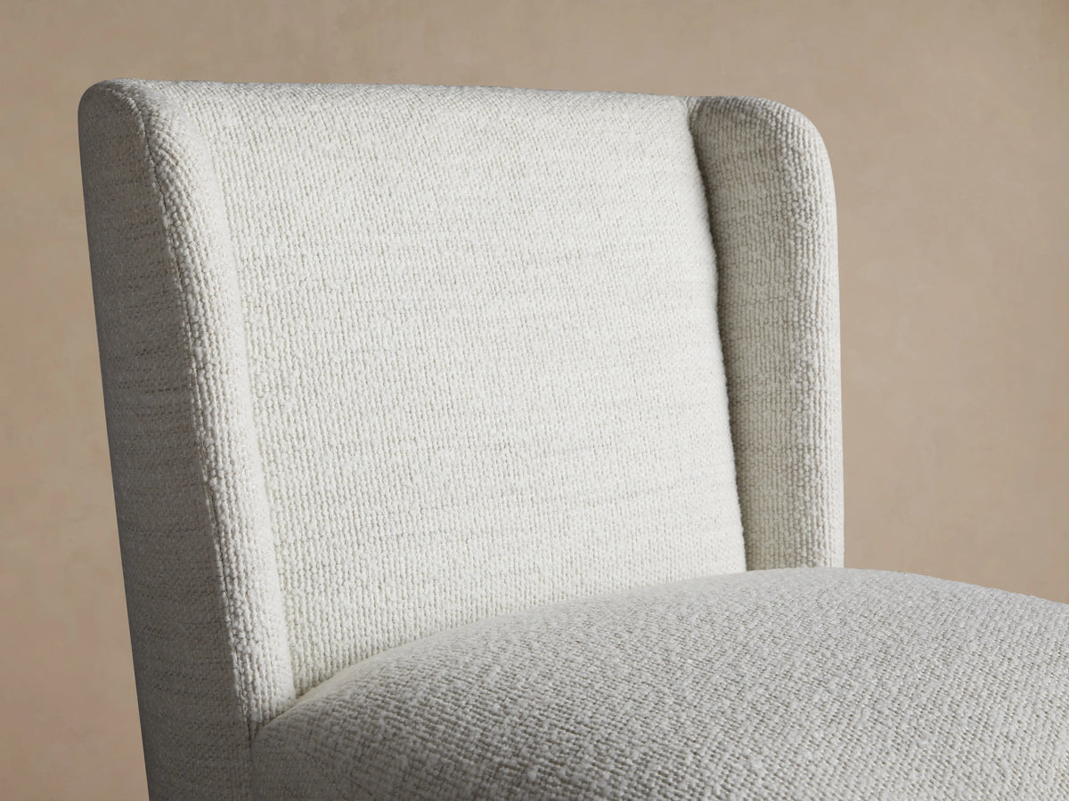 Mila Dining Chair in off-white Crypton® fabric, featuring a textured, soft surface, straight back, and clean lines on a wooden floor.