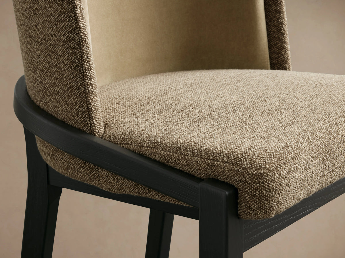 Mena Stool with black ash wood frame, beige and taupe fabric upholstery. Back view showing curved backrest and four legs.