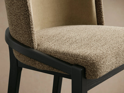 Mena Stool with black ash wood frame, beige and taupe fabric upholstery. Back view showing curved backrest and four legs.