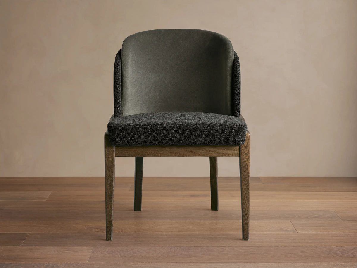 Mena Dining Chair, front. Dark gray layered fabric back and textured seat, solid ash wood frame with tapered legs.