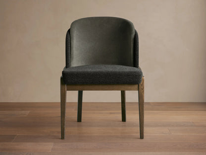 Mena Dining Chair, front. Dark gray layered fabric back and textured seat, solid ash wood frame with tapered legs.