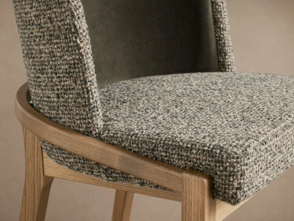 Mena Dining Chair. Front view: dark olive velvet back, speckled grey fabric seat/arms, light ash tapered legs.