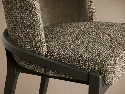 Close-up of Mena Dining Chair, showing multi-tone woven fabric seat & outer back, dark ash wood frame, and olive green inner backrest.