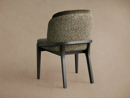 Mena Dining Chair with dark ash wood frame & tapered legs, angled rear. Curved back features green textured and dark velvet fabrics.