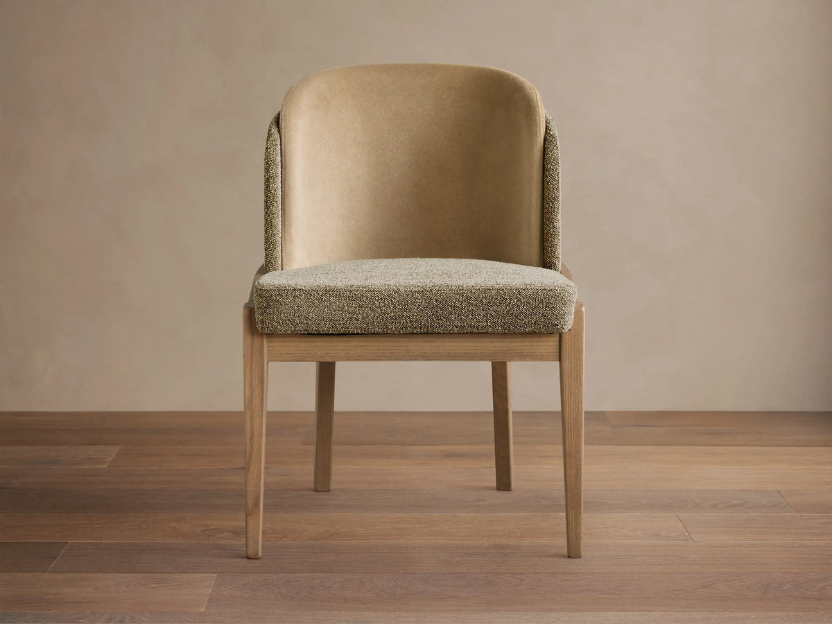 Mena Dining Chair, front view. Light ash wood frame, textured beige seat, and two-tone beige upholstered back.