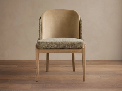 Mena Dining Chair, front view. Light ash wood frame, textured beige seat, and two-tone beige upholstered back.