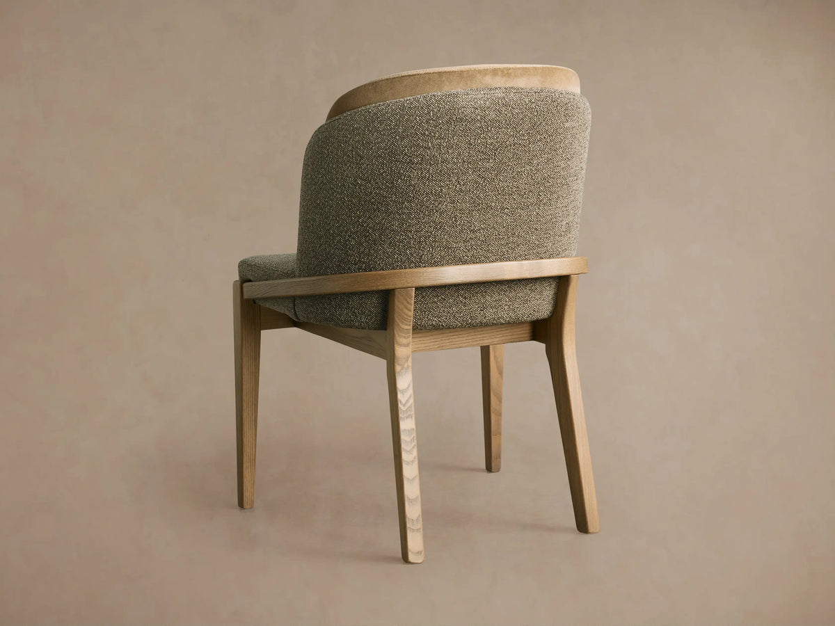 Mena Dining Chair, 3/4 back view. Natural ash wood frame, tapered legs. Two-tone back with olive textured & light beige fabrics.