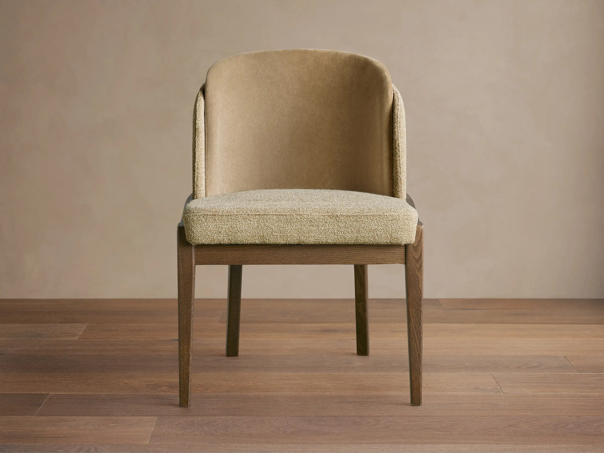 Front view of Mena Dining Chair with dark wood tapered legs and two-tone beige fabric upholstery, featuring a curved back.