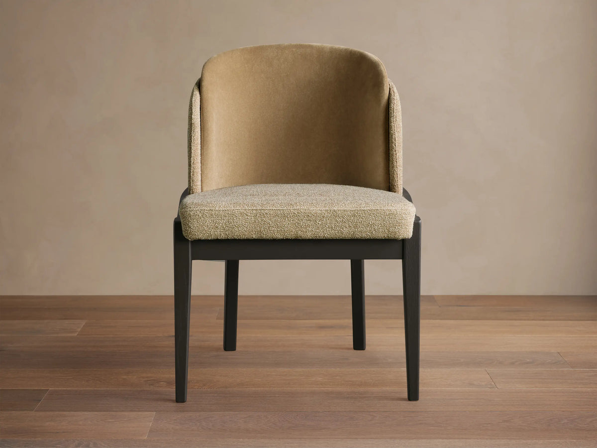 Mena Dining Chair, front view. Dark ash wood frame, curved back with tan inner and textured light beige outer fabric, light beige seat.