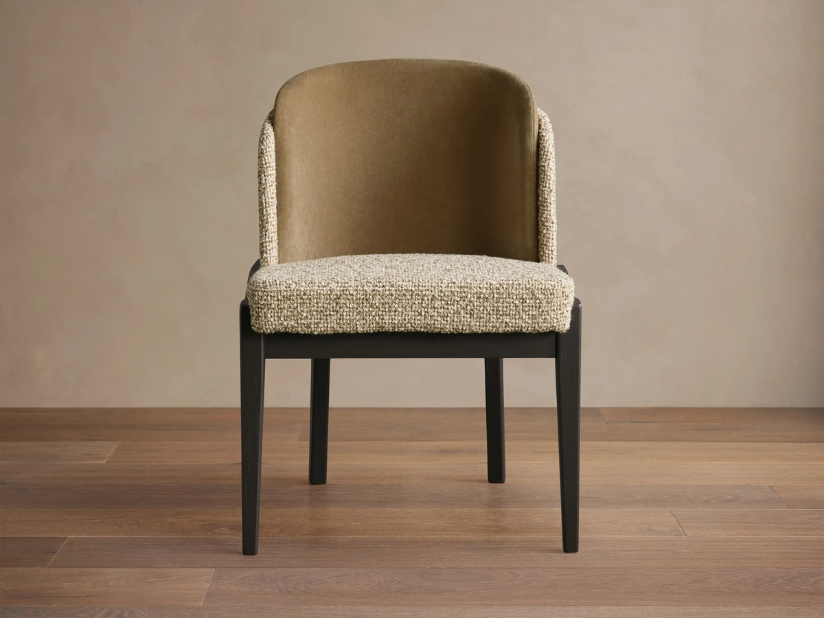 Mena Dining Chair, front. Dark wood frame, curved back with golden-brown fabric inside, textured light beige seat & outer back.