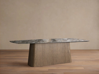 Vincenza Dining Table: grey marble-effect ceramic top with rounded corners on a textured light brown oak veneer pedestal base.