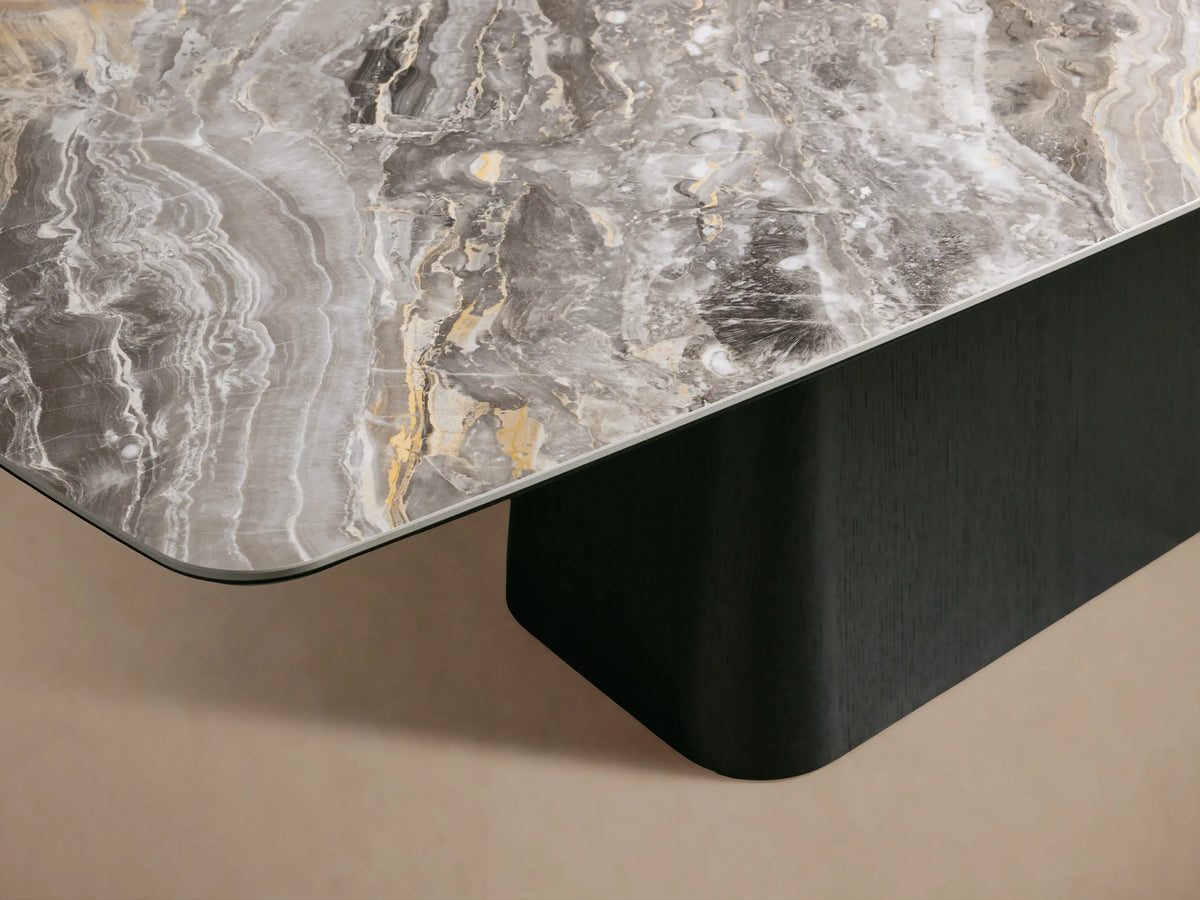Vincenza Dining Table with a ceramic tabletop mimicking calacatta marble atop a solid wood base with oak veneer, on a beige backdrop.