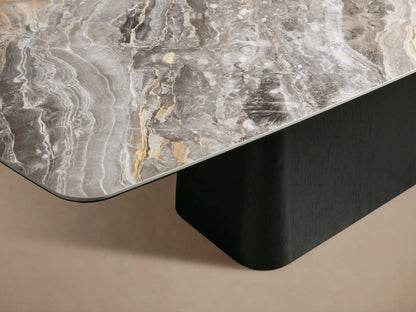 Vincenza Dining Table with a ceramic tabletop mimicking calacatta marble atop a solid wood base with oak veneer, on a beige backdrop.