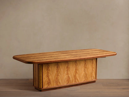 Front view of Palma Extension Dining Table, cerajeira wood veneer tabletop with striped graining, arched base, and dark primavera trim.