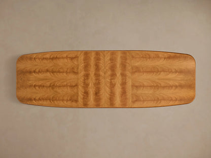 Top-down view of the extended Palma Extension Dining Table, showing rich cerajeira wood veneers with cathedral grain and two perpendicular grain leaves.