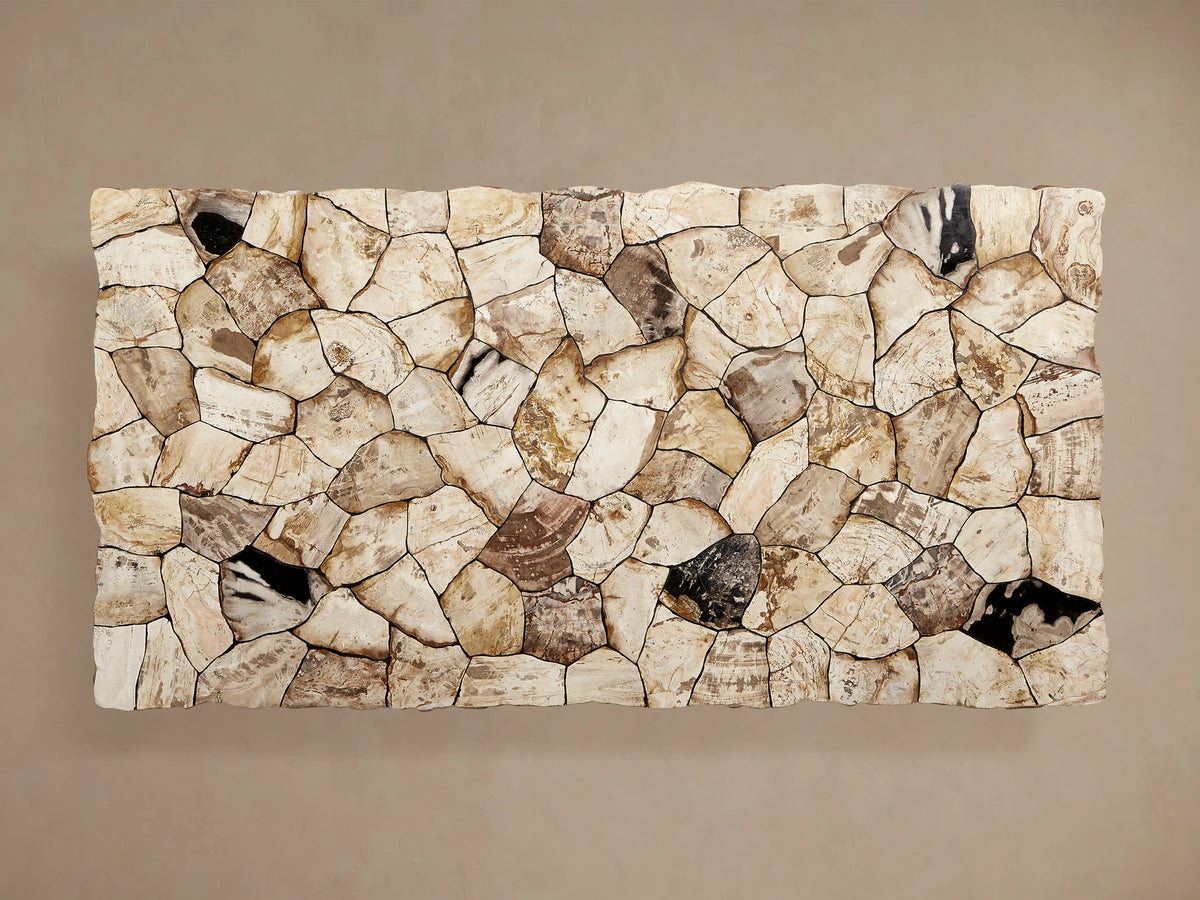 Edge view of the Petra Dining Table with a petrified wood surface. The tabletop shows a mix of dark and light tones with natural variations.