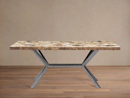 Petrified wood tabletop with irregular stone pattern in earthy tones, detailed texture, and visible iron base below.