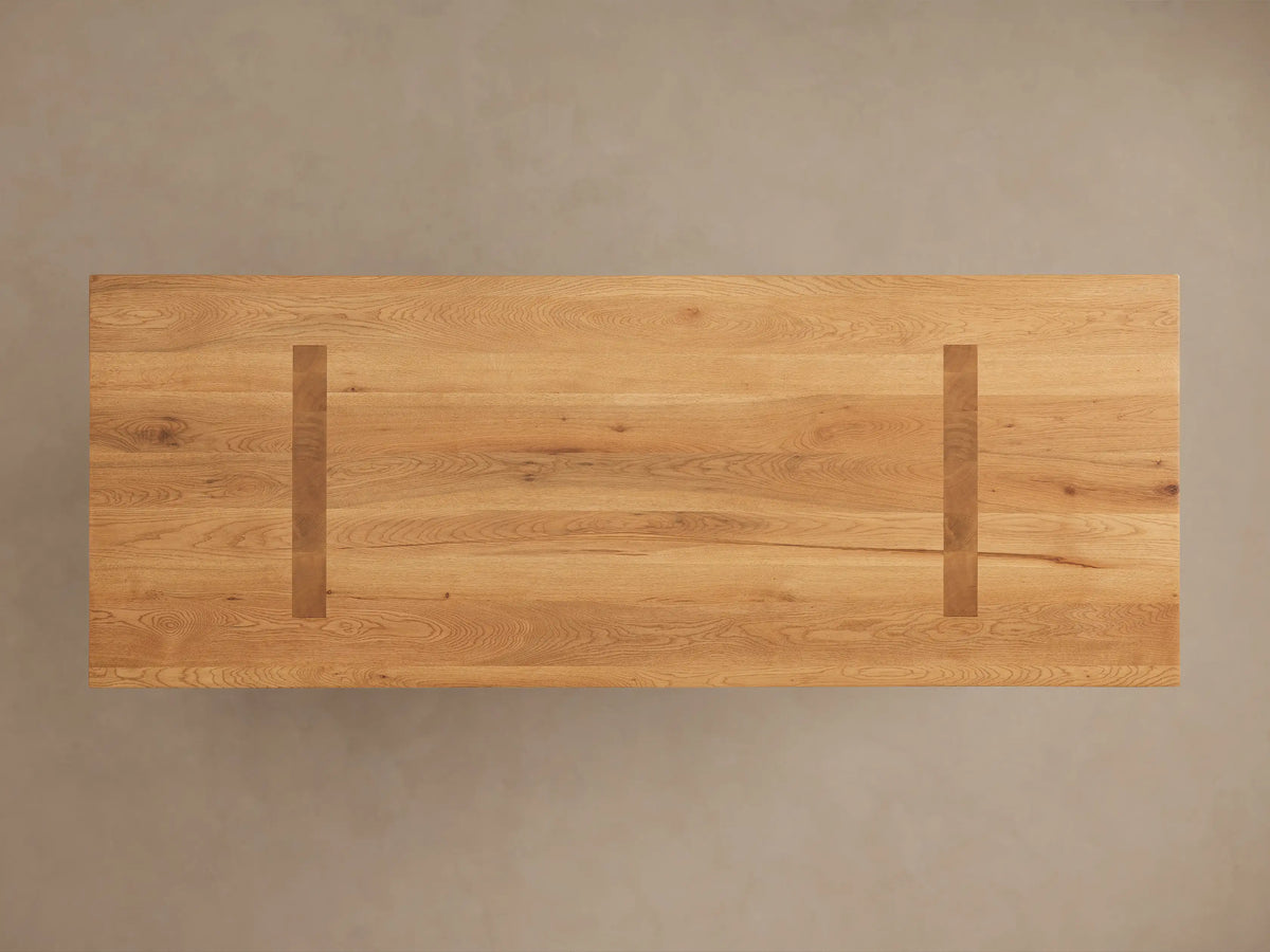Panta Dining Table made of Romanian red oak, showing natural grain patterns, knots, and a polished, hand-stained finish.