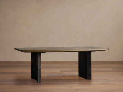 Dark, textured wood Polanco Dining Table™ with weathered steel base, surrounded by upholstered chairs in a modern dining room.