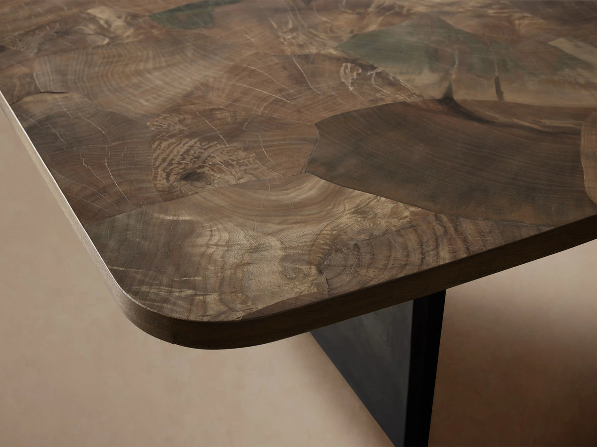 Polanco Dining Table: Close-up of round corner, featuring oyster-cut wood top with varied brown tones, intricate grain, dark base.