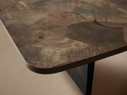 Polanco Dining Table: Close-up of round corner, featuring oyster-cut wood top with varied brown tones, intricate grain, dark base.