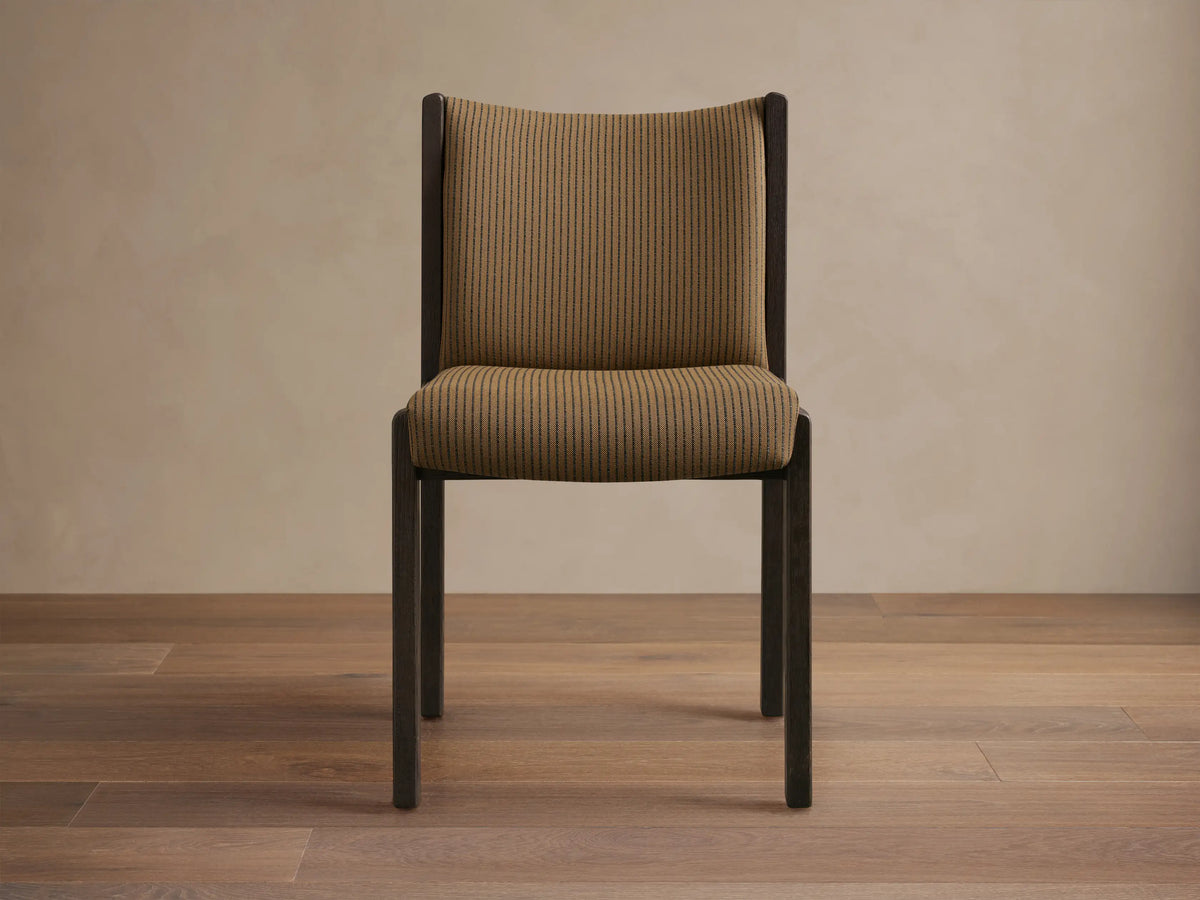 Front-side view of Paradiso Dining Chair, dark brown oak frame with tan fabric seat and backrest featuring thin vertical stripes.