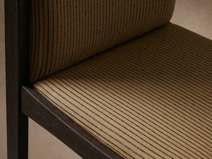 Front view of Paradiso Dining Chair with dark brown solid oak frame and tan upholstery with thin dark vertical stripes.