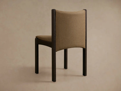 Close-up of the tan and black striped upholstery and dark oak frame of the Paradiso Dining Chair.
