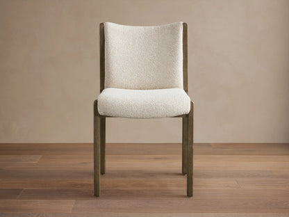 Interior view of Paradiso Dining Chair with light oak wood frame and beige striped upholstery, placed at an oval dining table.