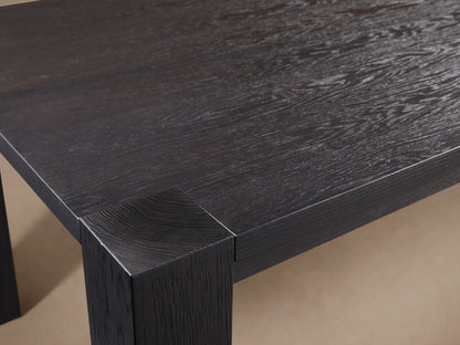 Parsons Dining Table made of dark Romanian oak wood, featuring a simple rectangular design with four sturdy legs on a hardwood floor.