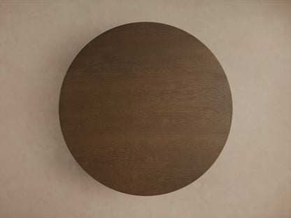 Close-up of Perth Round Dining Table. Dark brown wood grain visible on the round tabletop edge and curved pedestal base.