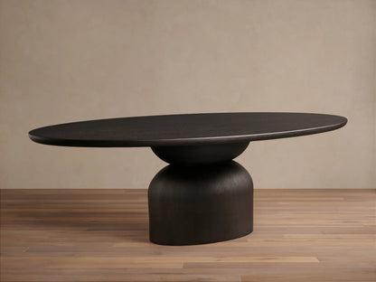 Dark wood Perth Oval Dining Table with an oval top and a sturdy, rounded pedestal base, resting on a wooden floor.